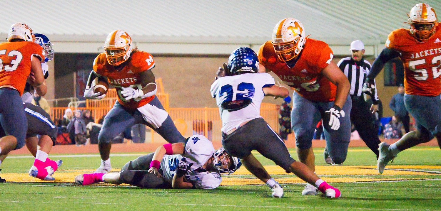 Dawson Elmore (53), Jackson Anderson (56) and Nate Griffen (52) create a wide path for ballcarrier Trevion Sneed to burst through. Elmore made the offensive first team; Anderson was offensive lineman of the year; Griffen was second team on both offense and defense; and Sneed was district MVP. [print available]